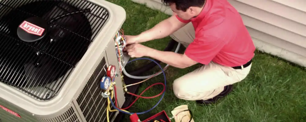 HVAC technician servicing an outdoor air conditioner unit in Palm Springs, CA